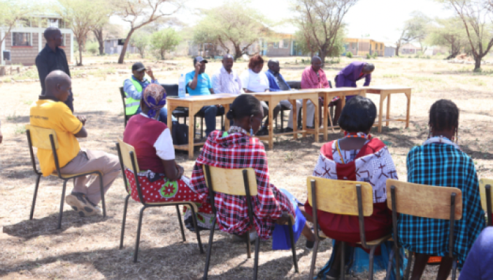 A group of people sitting around a table.