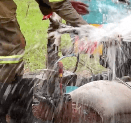 A person is spraying water on something.