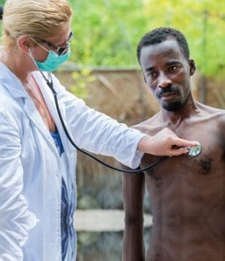 A doctor is checking the blood pressure of a man.